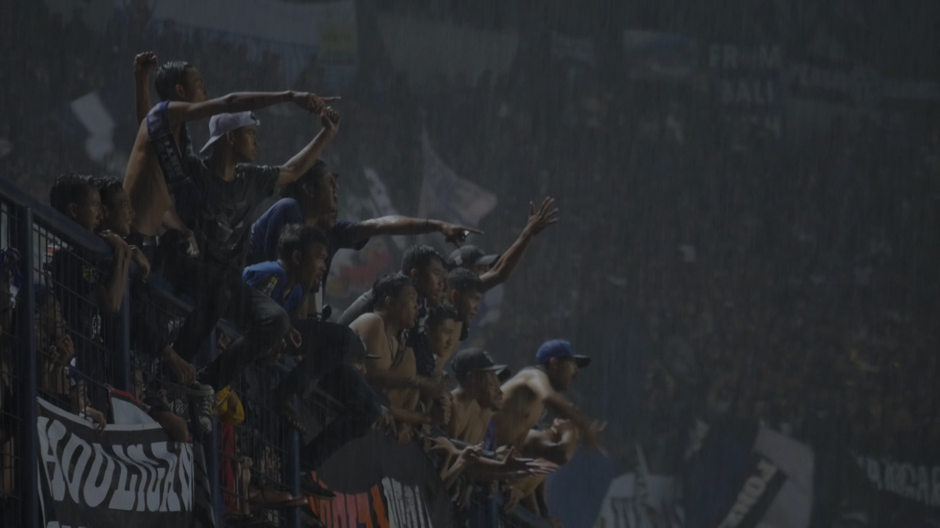 Football fans in smoky stadium atmosphere